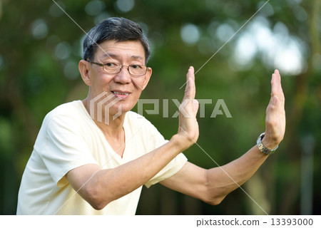 One male chinese elderly doing morning exercise in a park 13393000