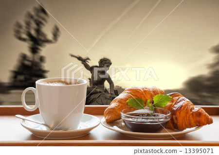 Paris coffee with croissants against sunset over city in France 13395071