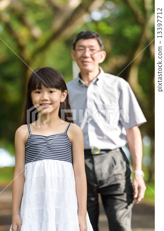 Chinese granddaughter and grandfather in the park 13397712
