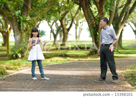 Chinese granddaughter and grandfather playing ball game in the park 13398101