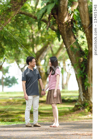 Chinese couple walking in a park 13405348
