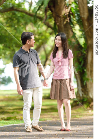 Chinese couple walking in a park 13405350