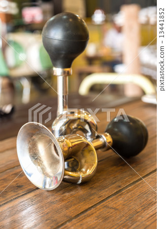 Vintage brass bicycle horn on wooden Table 13441852