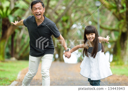 Chinese father and daughter playing in the park 13443943