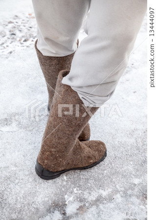 Male feet with traditional Russian felt boots 13444097