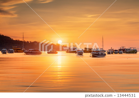 sunrise with colorful sky and boats on the beach 13444531