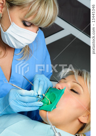 dentist with patient, cleaning and curing 13445346