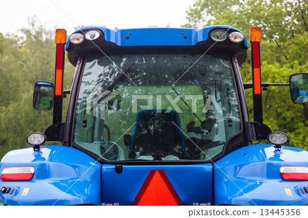 Cabin of the new blue tractor. Rear view. Close up. Cabin of the new blue tractor. Rear view. Close up. 13445356