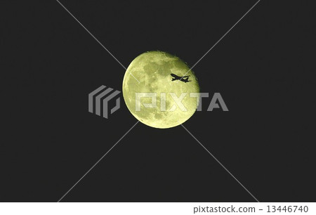 Boeing 777 Jet airliner flying at night silently crosses the beautiful moon shining in the night sky 13446740