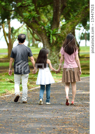 Back view of 1 happy chinese family walking in the park 13447928