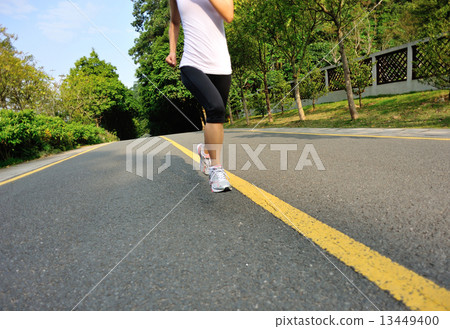 fitness woman running at forest road  13449400