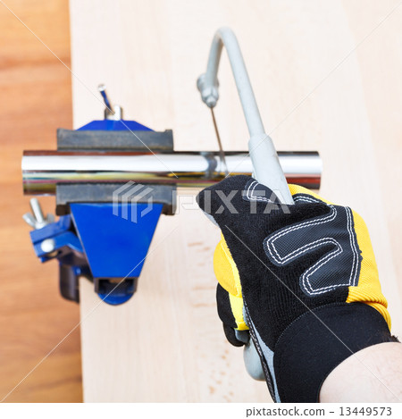 sanitary technician saws metal trap pipe 13449573