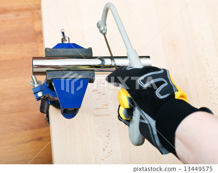 plumber saws metal trap pipe gripped in vice plumber saws metal trap pipe gripped in vice 13449575