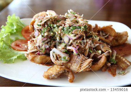 Thai food fry fish with herb spicy salad on wood background 13459016