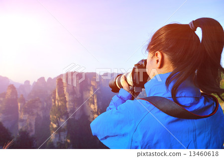 woman photographer taking photo at zhangjiajie national forest park,china woman photographer taking photo at zhangjiajie national forest park,china 13460618