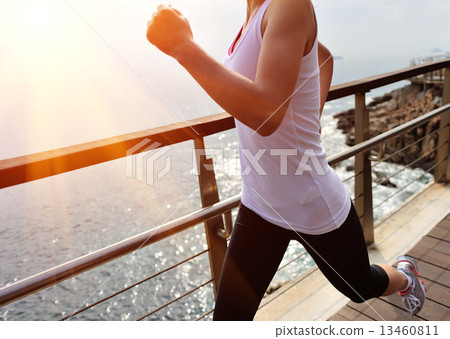 healthy lifestyle sports woman running on wooden boardwalk seaside  13460811