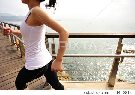 healthy lifestyle sports woman running on wooden boardwalk seaside  13460812