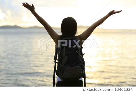 cheering woman hiker open arms to the sunrise stand at seaside cheering woman hiker open arms to the sunrise stand at seaside 13461324