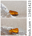 amber stone shine baltic sea sand background 13461423