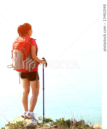 hiking woman stand seaside mountain rock looking at the view  13462048