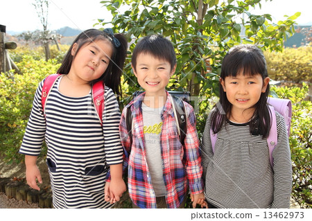A friend of a smiley elementary school student carrying a school bag A friend of a smiley elementary school student carrying a school bag 13462973