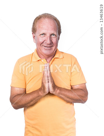 Handsome old man in orange polo-shirt doing Thai gesture or begg Handsome old man in orange polo-shirt doing Thai gesture or begg 13463619