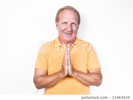 Handsome old man in orange polo-shirt doing Thai gesture or begg 13463620