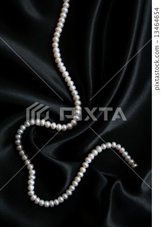 White pearls on the black silk 13464654