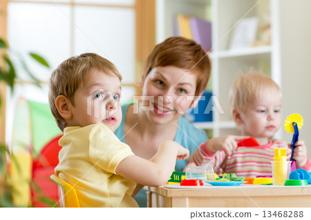 kids and mother playing colorful clay toy at home kids and mother playing colorful clay toy at home 13468288