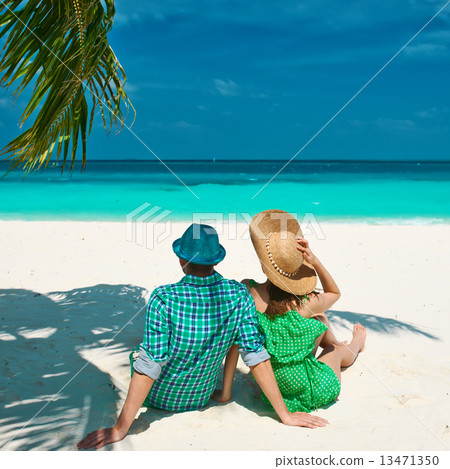 Couple in green on a beach at Maldives Couple in green on a beach at Maldives 13471350