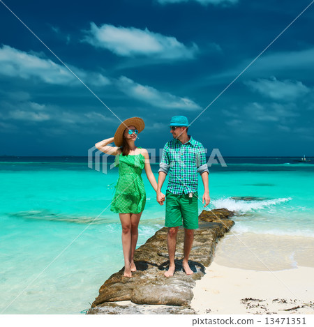 Couple in green on a beach at Maldives Couple in green on a beach at Maldives 13471351