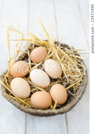 Brown eggs in a wicker basket 13471499