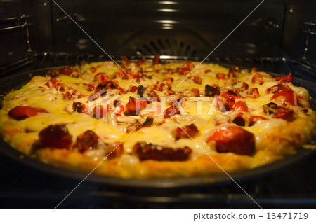 Pizza baking in oven 13471719