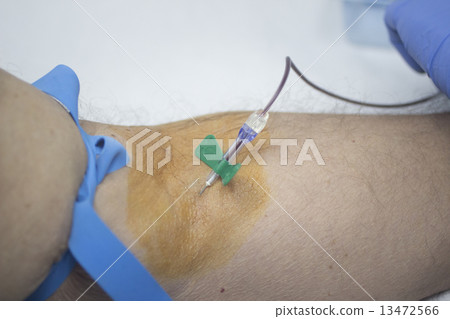 Nurse and male patient blood sample donation 13472566