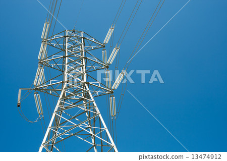 High voltage post against clear blue sky background  13474912