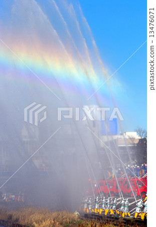 Rainbow over splashes of simultaneous fire-fighting at the firefighting initiation ceremony 13476071