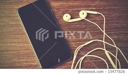 Russia, Chelyabinsk, January 7, 2015.  new black Apple iPhone 6 and headphones on the table 13477826