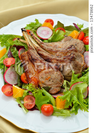 Grilled chicken with lamb with bone. Served with salad. 13478662