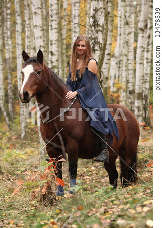 Amazing girl riding a horse without any equipment in autumn fore 13478839