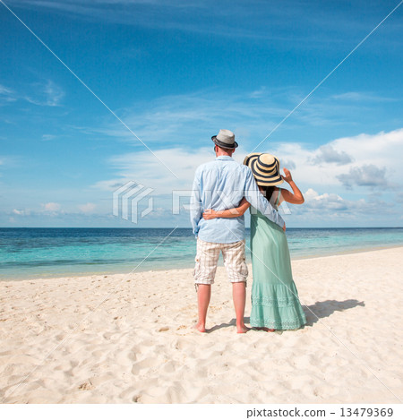 Vacation Couple walking on tropical beach Maldives. 13479369
