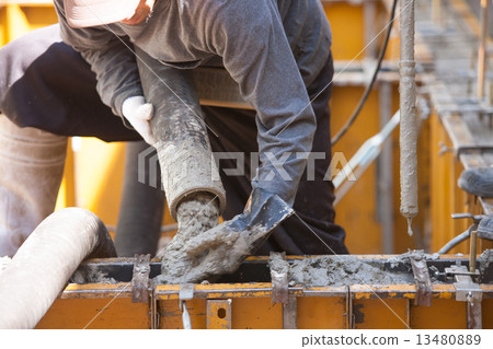 Concrete placing on raw foundation construction frame of housing 13480889