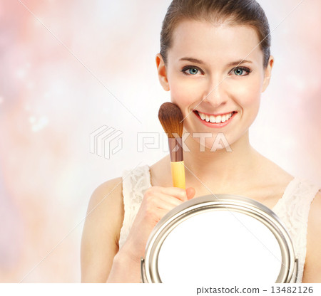 A beautiful woman and a makeup brush A beautiful woman and a makeup brush 13482126