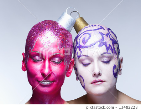 Two women posing as Christmas ornaments Two women posing as Christmas ornaments 13482228