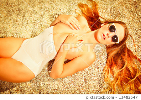attractive girl on beach with sunglasses 13482547
