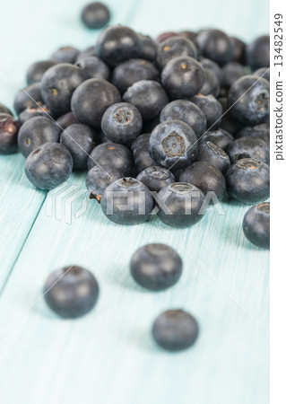 Blueberries - Delicious juicy blueberries on a blue wooden table Blueberries - Delicious juicy blueberries on a blue wooden table 13482549