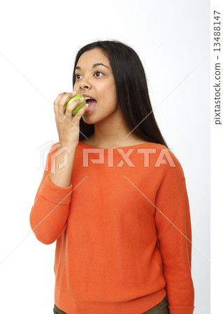 Asian woman gnawing apple Asian woman gnawing apple 13488147
