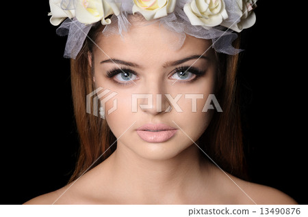 Beautiful woman with a wreath of flowers 13490876
