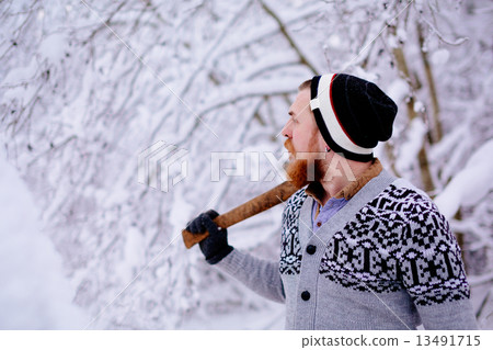 Lumberjack in the snowy winter forest Lumberjack in the snowy winter forest 13491715