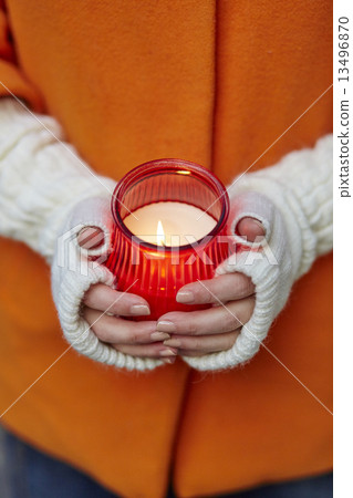 Woman holding burning candle 13496870