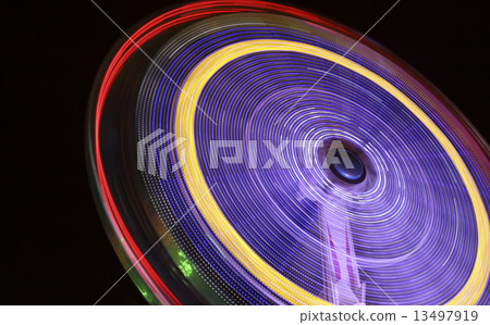A rotating ride at the Oktoberfest at night A rotating ride at the Oktoberfest at night 13497919